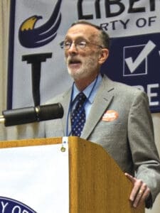 john-buckley-at-lectern-rgb-96dpi-at-5-5inw